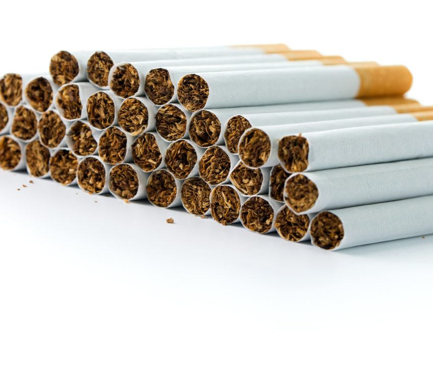 A close-up photo of stacked cigarettes.