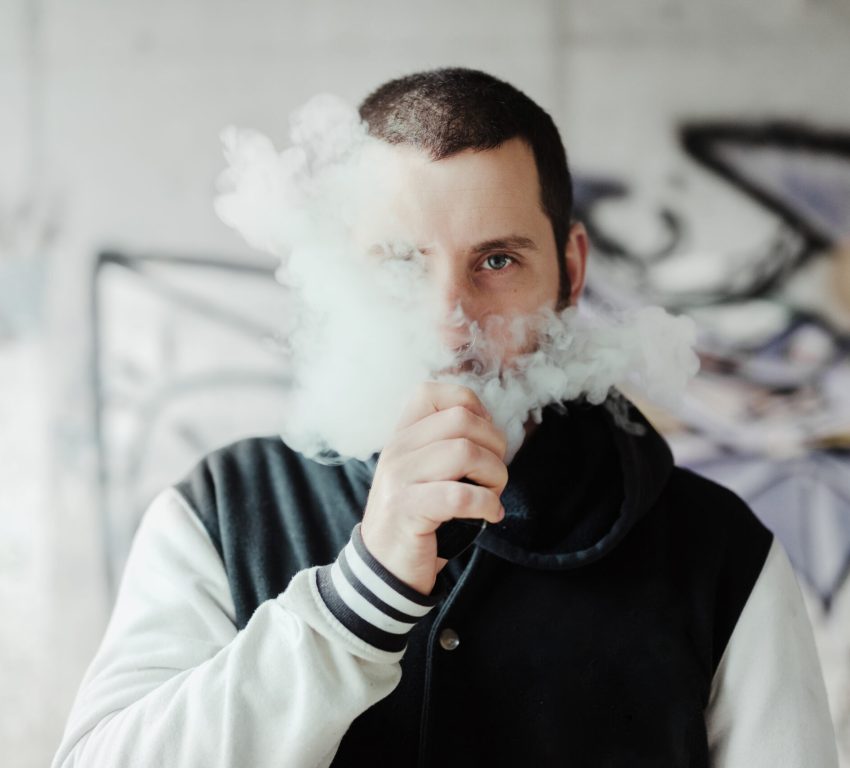 young man vaping his electronic cigarette